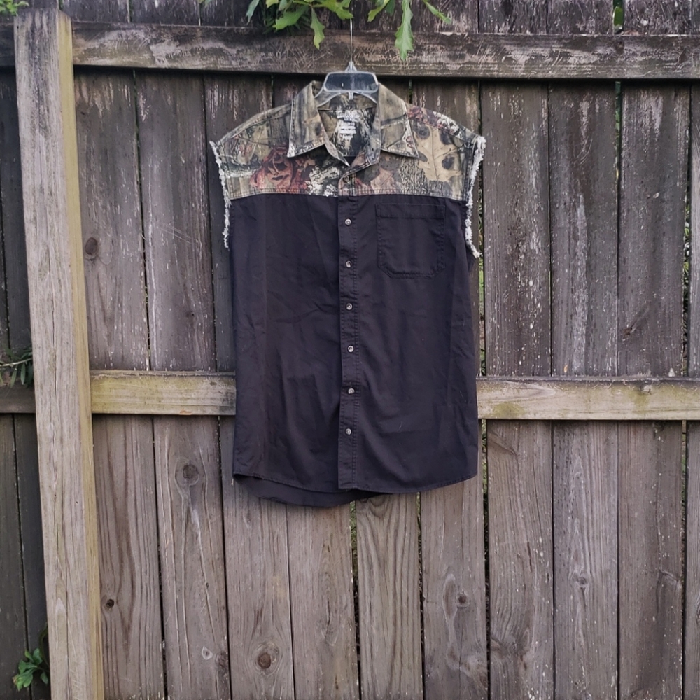 Black and camouflage sleeveless button up shirt.